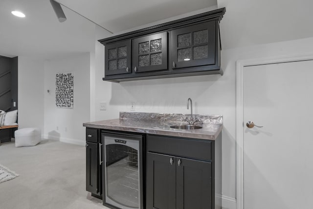 712 Riverbend Ave, Powell, OH 43065 - indoor wet bar with wine cooler, baseboards, and light carpet