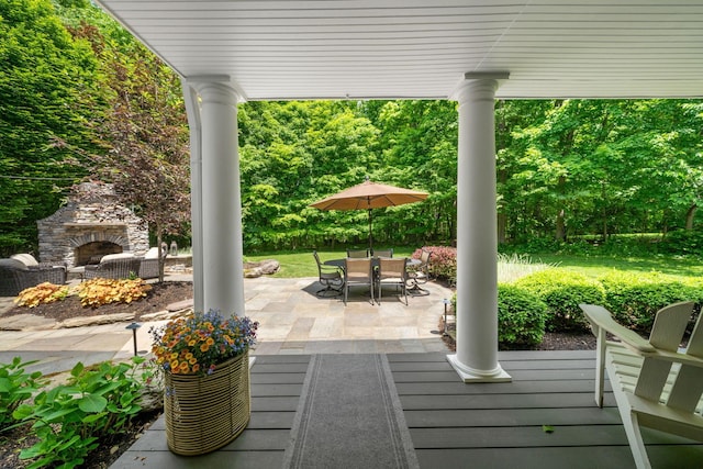 712 Riverbend Ave, Powell, OH 43065 - deck with an outdoor stone fireplace, a patio area, and outdoor dining space
