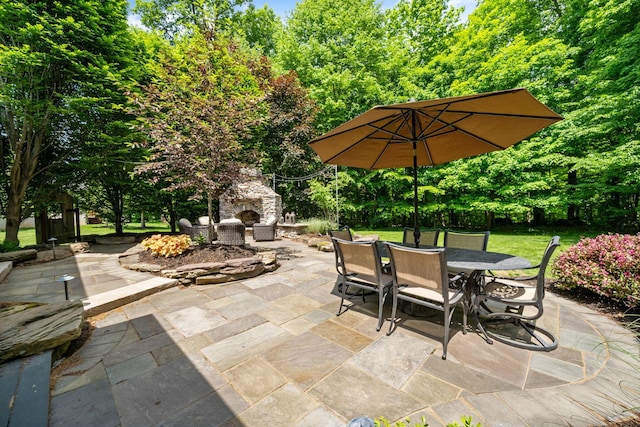 712 Riverbend Ave, Powell, OH 43065 - view of patio featuring an outdoor stone fireplace and outdoor dining area