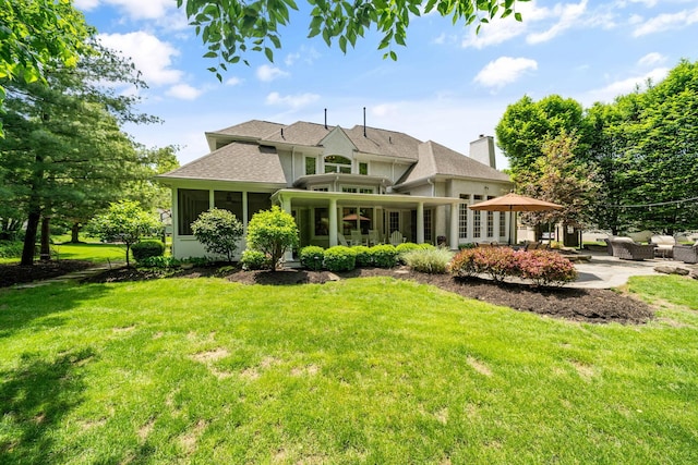 712 Riverbend Ave, Powell, OH 43065 - rear view of house with a lawn, roof with shingles, and a patio area