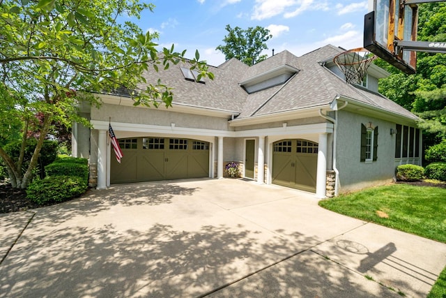 712 Riverbend Ave, Powell, OH 43065 - view of front of home featuring an attached garage, roof with shingles, concrete driveway, stucco siding, and stone siding