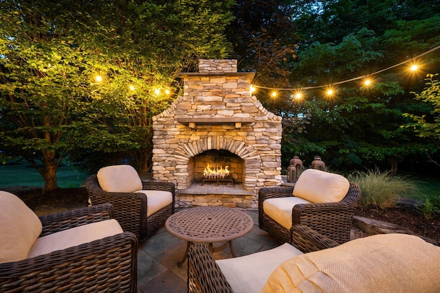 712 Riverbend Ave, Powell, OH 43065 - patio at night with an outdoor stone fireplace and a patio