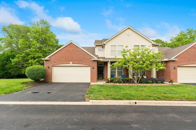 308 Postage Cir, Pickerington, OH 43147 - view of front of house featuring an attached garage, a front yard, brick siding, and driveway
