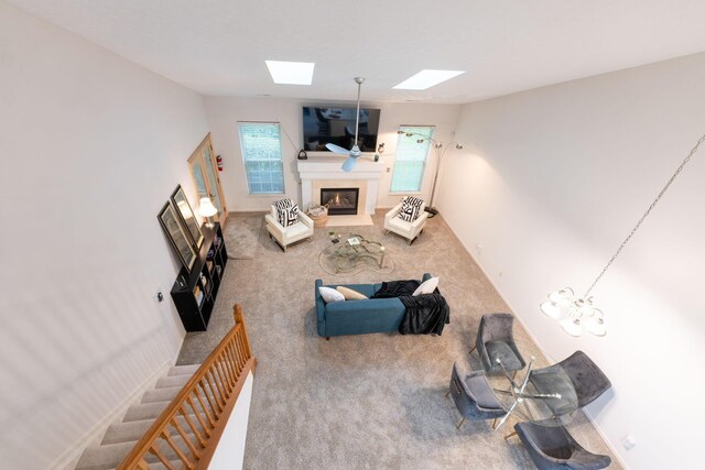 308 Postage Cir, Pickerington, OH 43147 - carpeted living area with a skylight and a glass covered fireplace