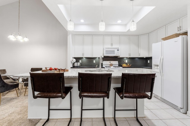 308 Postage Cir, Pickerington, OH 43147 - kitchen featuring white appliances, a tray ceiling, tasteful backsplash, white cabinets, and a sink