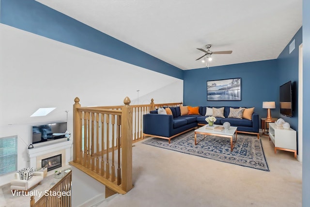 308 Postage Cir, Pickerington, OH 43147 - living area with a ceiling fan, carpet flooring, a glass covered fireplace, a skylight, and baseboards
