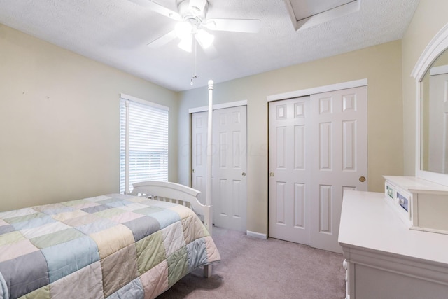 308 Postage Cir, Pickerington, OH 43147 - bedroom featuring multiple closets, light carpet, a textured ceiling, and a ceiling fan
