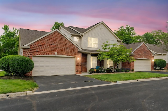 308 Postage Cir, Pickerington, OH 43147 - view of front of property with a garage, brick siding, asphalt driveway, a yard, and roof with shingles