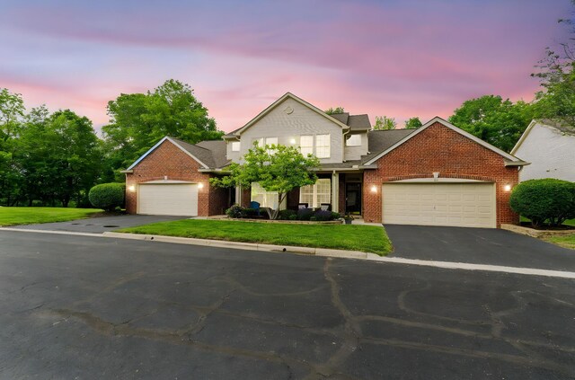 308 Postage Cir, Pickerington, OH 43147 - traditional-style house featuring a garage, brick siding, asphalt driveway, and a yard