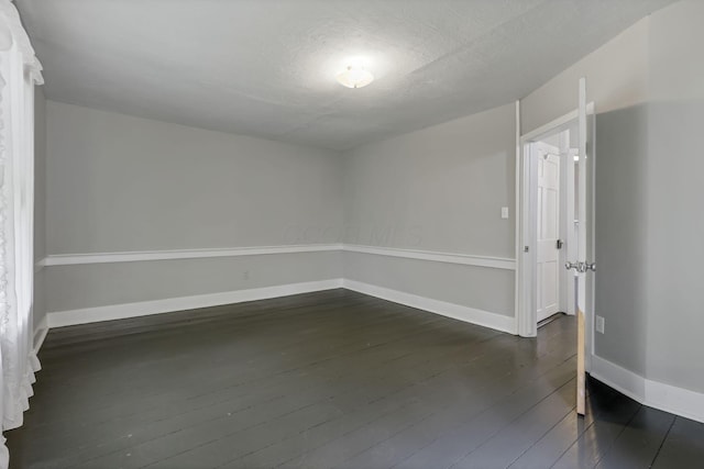 1625 Stringtown Rd NE, Lancaster, OH 43130 - spare room with baseboards and dark wood-style floors