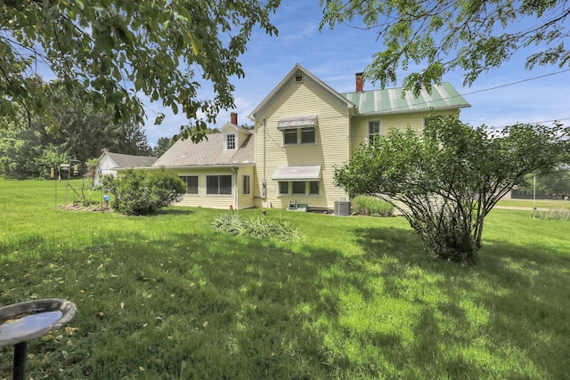 1625 Stringtown Rd NE, Lancaster, OH 43130 - back of house with a chimney, central AC, and a yard