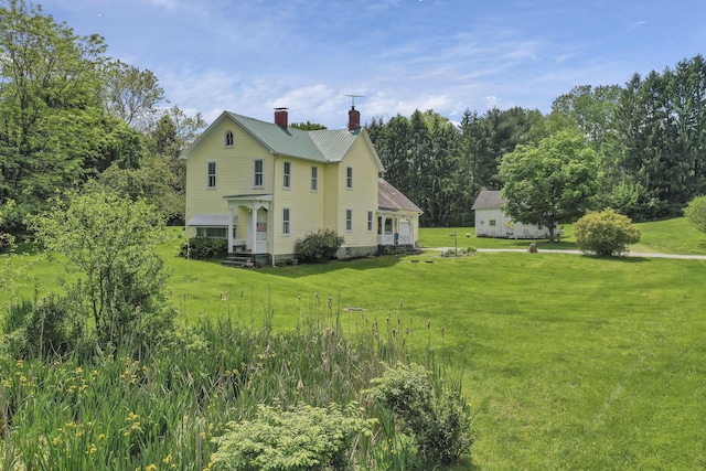 1625 Stringtown Rd NE, Lancaster, OH 43130 - view of property exterior featuring a chimney, a yard, and metal roof
