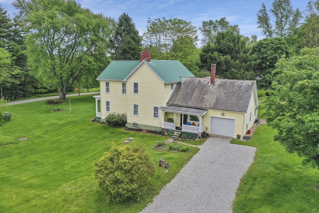 1625 Stringtown Rd NE, Lancaster, OH 43130 - view of front of home with a chimney, gravel driveway, an attached garage, and a front yard