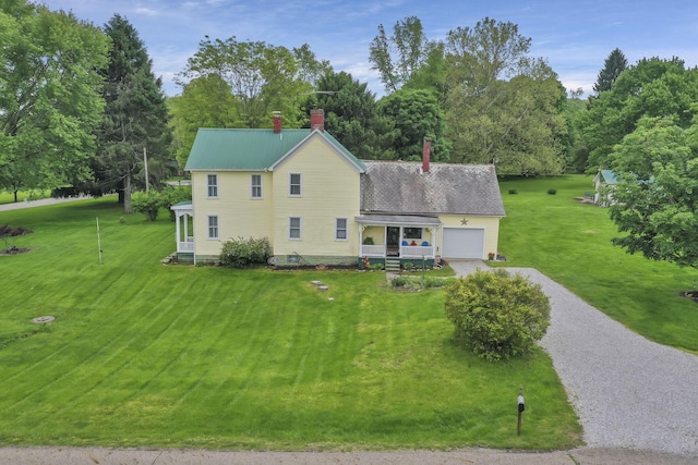1625 Stringtown Rd NE, Lancaster, OH 43130 - view of front of house with driveway, a chimney, an attached garage, and a front yard