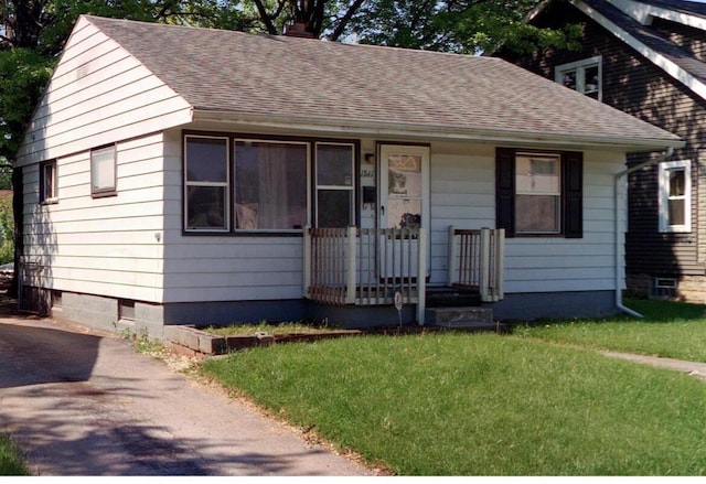 1841 Agler Rd, Columbus, OH 43224 - bungalow-style home featuring roof with shingles, a front yard, a porch, and a chimney