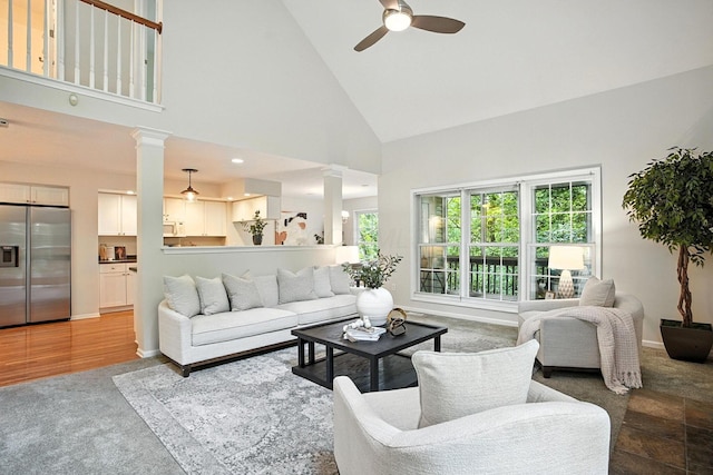 1223 Sanctuary Pl, Columbus, OH 43230 - carpeted living area with decorative columns, high vaulted ceiling, and ceiling fan