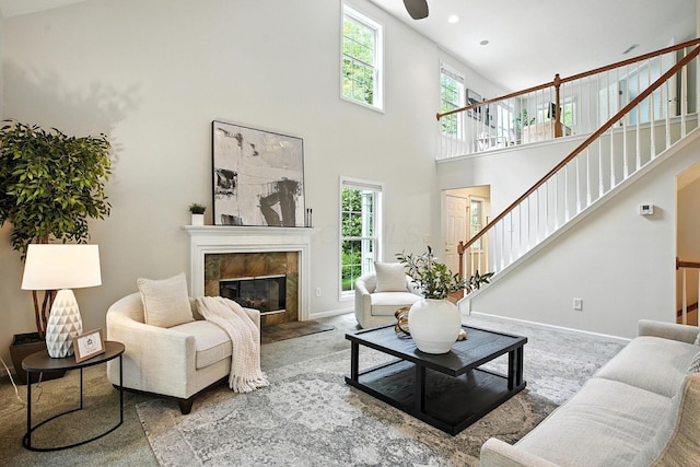 1223 Sanctuary Pl, Columbus, OH 43230 - living area featuring stairway, a high end fireplace, healthy amount of natural light, a high ceiling, and carpet floors