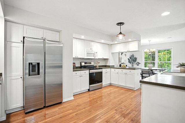 1223 Sanctuary Pl, Columbus, OH 43230 - kitchen with stainless steel appliances, dark countertops, white cabinetry, light wood-type flooring, and recessed lighting