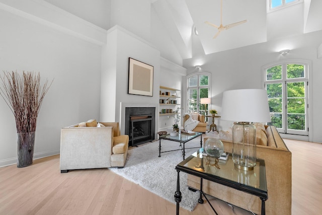 382 E Town St, Columbus, OH 43215 - living area with high vaulted ceiling, a fireplace with flush hearth, light wood-type flooring, and healthy amount of natural light