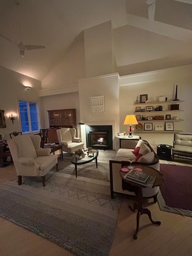 382 E Town St, Columbus, OH 43215 - living room featuring high vaulted ceiling, a warm lit fireplace, a ceiling fan, and wood finished floors