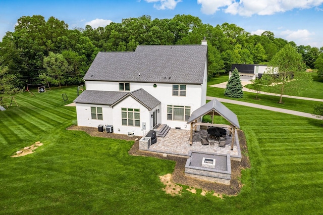 5046 Clark-Shaw Rd, Powell, OH 43065 - back of property with a gazebo, stucco siding, a patio area, a fire pit, and a lawn