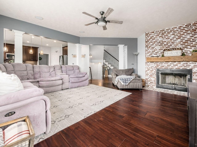 5046 Clark-Shaw Rd, Powell, OH 43065 - living room with ornate columns, ceiling fan, wood finished floors, and stairway