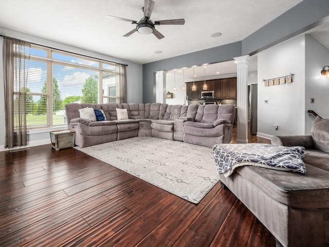 5046 Clark-Shaw Rd, Powell, OH 43065 - living area featuring a ceiling fan, dark wood-style flooring, baseboards, and ornate columns