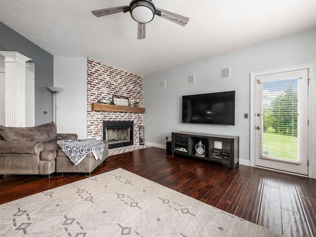5046 Clark-Shaw Rd, Powell, OH 43065 - living area featuring wood finished floors, a fireplace, ceiling fan, and baseboards