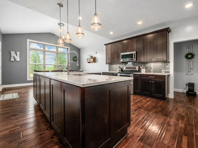 5046 Clark-Shaw Rd, Powell, OH 43065 - kitchen featuring stainless steel appliances, dark wood-type flooring, a sink, dark brown cabinets, and vaulted ceiling