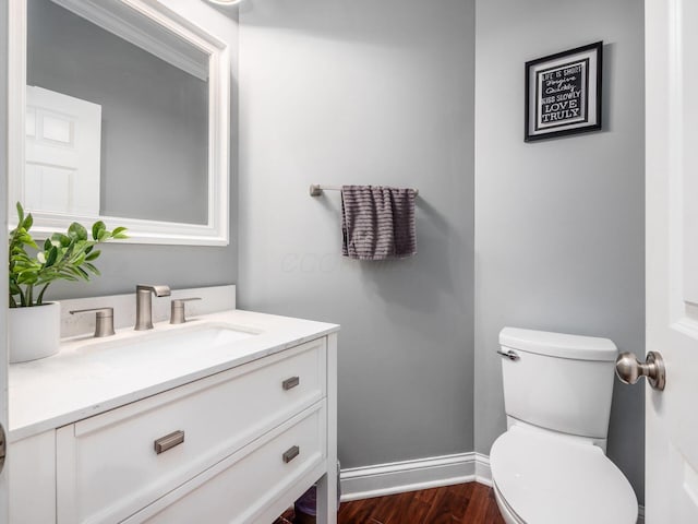 5046 Clark-Shaw Rd, Powell, OH 43065 - half bath featuring vanity, toilet, wood finished floors, and baseboards