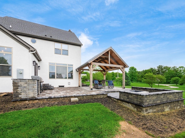 5046 Clark-Shaw Rd, Powell, OH 43065 - rear view of property featuring a gazebo, stucco siding, a patio, and a lawn