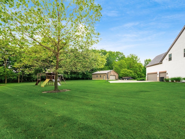 5046 Clark-Shaw Rd, Powell, OH 43065 - view of green lawn featuring a playground, a garage, and view of scattered trees
