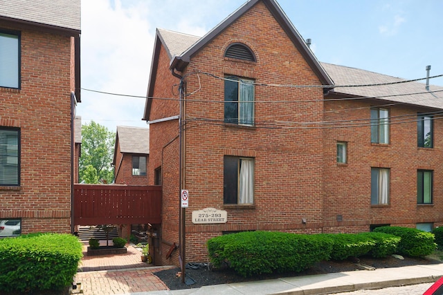 277 Lear St Unit 11, Columbus, OH 43206 - view of side of home featuring brick siding and a shingled roof