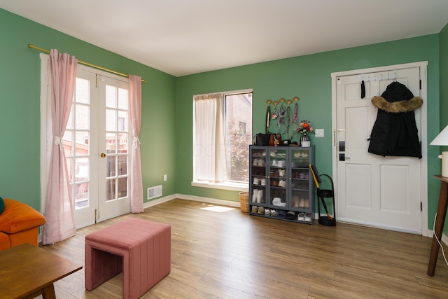 277 Lear St Unit 11, Columbus, OH 43206 - living area featuring french doors, wood finished floors, and baseboards