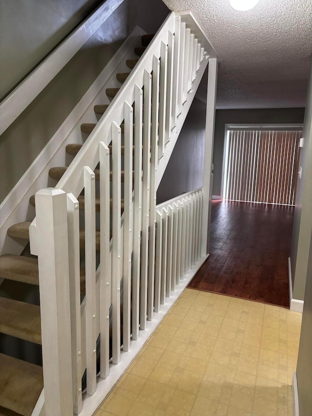 2037 Burbridge Ln Unit 31B, Hilliard, OH 43026 - stairs featuring tile patterned floors, a textured ceiling, and wine cooler