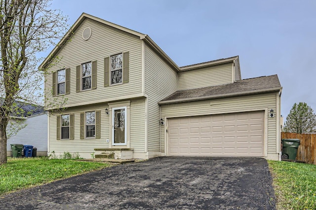 1041 Clifton Chase Dr, Galloway, OH 43119 - view of front of house with asphalt driveway, a garage, and fence