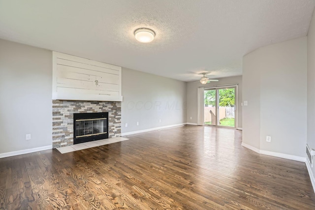 1041 Clifton Chase Dr, Galloway, OH 43119 - unfurnished living room with ceiling fan, a fireplace with flush hearth, wood finished floors, a textured ceiling, and baseboards