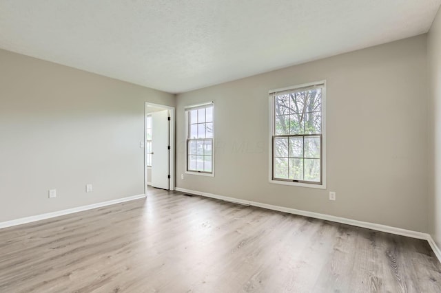 1041 Clifton Chase Dr, Galloway, OH 43119 - empty room featuring baseboards, wood finished floors, and a textured ceiling