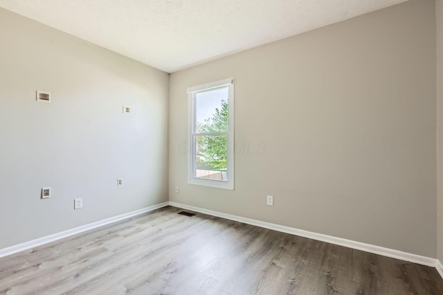 1041 Clifton Chase Dr, Galloway, OH 43119 - empty room featuring wood finished floors, baseboards, and a textured ceiling