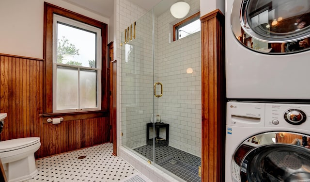 758 S Front St, Columbus, OH 43206 - clothes washing area featuring stacked washer / drying machine, a wainscoted wall, and wooden walls