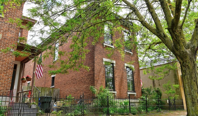 758 S Front St, Columbus, OH 43206 - view of property exterior with brick siding and a fenced front yard