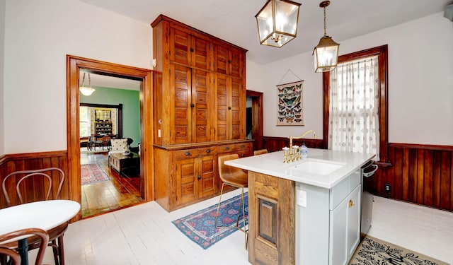 758 S Front St, Columbus, OH 43206 - bathroom with wainscoting, hardwood / wood-style floors, wooden walls, a chandelier, and vanity