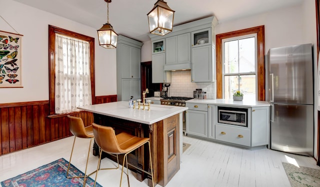 758 S Front St, Columbus, OH 43206 - kitchen with appliances with stainless steel finishes, gray cabinets, a wainscoted wall, light countertops, and a sink