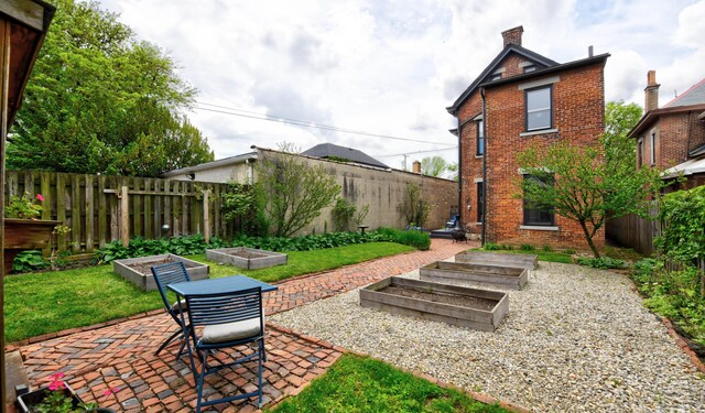 758 S Front St, Columbus, OH 43206 - fenced backyard with a vegetable garden and a patio