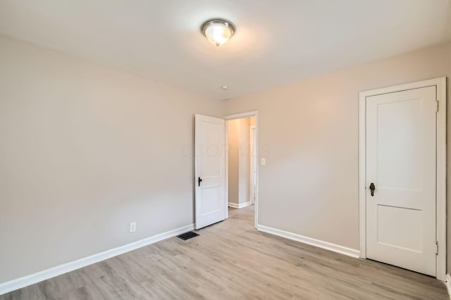 2454 Joyce Ave, Columbus, OH 43211 - unfurnished bedroom featuring baseboards and light wood finished floors