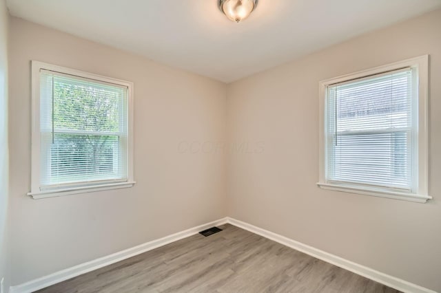 2454 Joyce Ave, Columbus, OH 43211 - spare room with light wood-style floors and baseboards