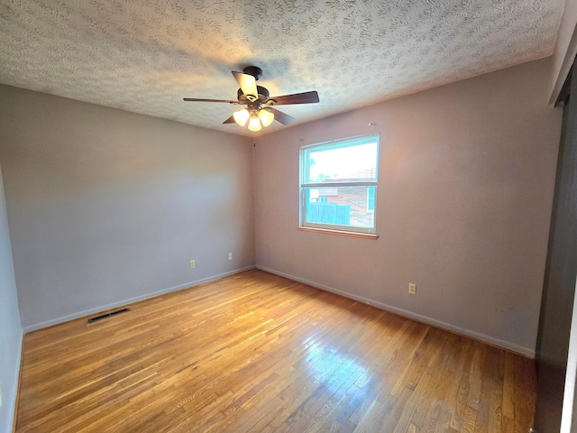 568 Brookdale Dr, West Jefferson, OH 43162 - unfurnished room with light wood-style flooring, baseboards, a ceiling fan, and a textured ceiling