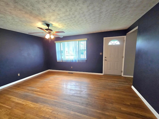 568 Brookdale Dr, West Jefferson, OH 43162 - foyer entrance featuring plenty of natural light, ceiling fan, wood finished floors, baseboards, and a textured ceiling