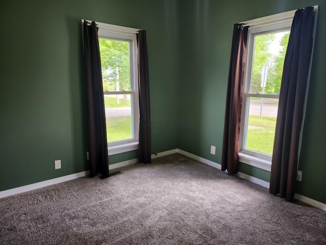7703 County Road 91, Lewistown, OH 43333 - empty room with carpet flooring, healthy amount of natural light, and baseboards