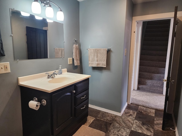 7703 County Road 91, Lewistown, OH 43333 - bathroom with baseboards, vanity, and stone finish flooring